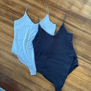 Set of two black and white v-neck bodysuits
